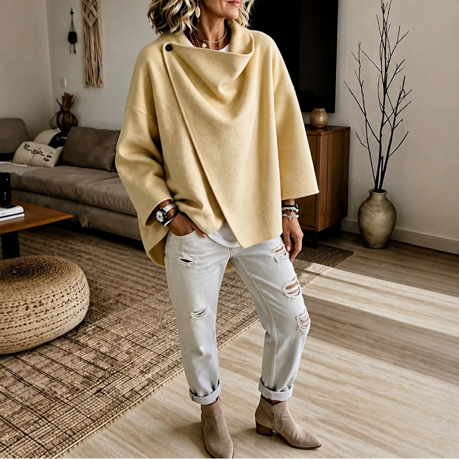 Warm yellow version of the asymmetric button wrap cape jacket paired with cuffed white jeans and ankle boots.