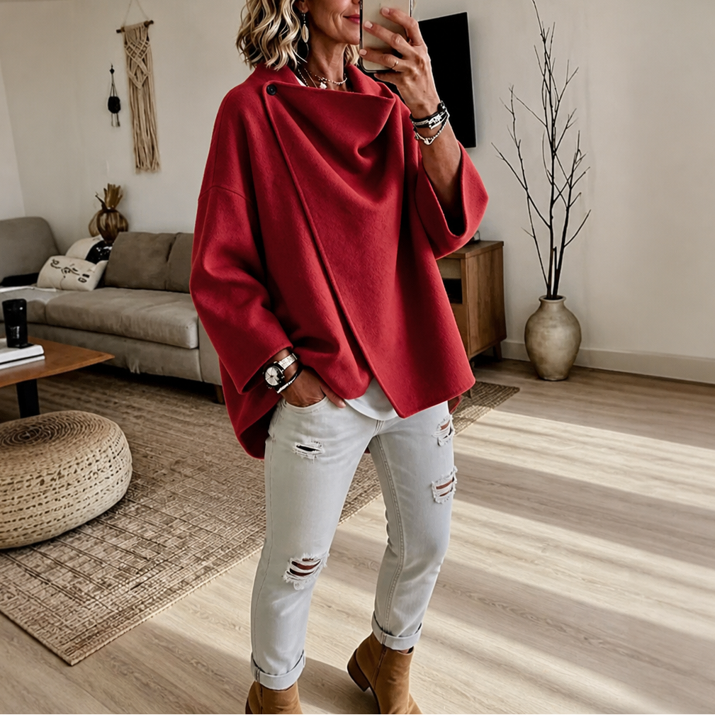 Bright red version of the asymmetric button wrap cape jacket styled with white distressed jeans and ankle boots.