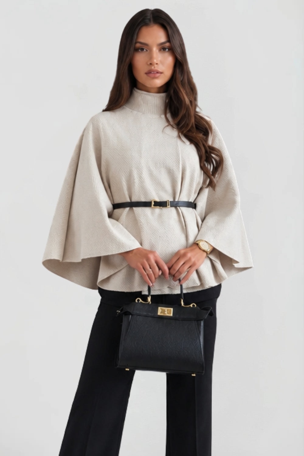 Front view of the cream belted cape jacket with textured finish, high collar, and wide cape sleeves.