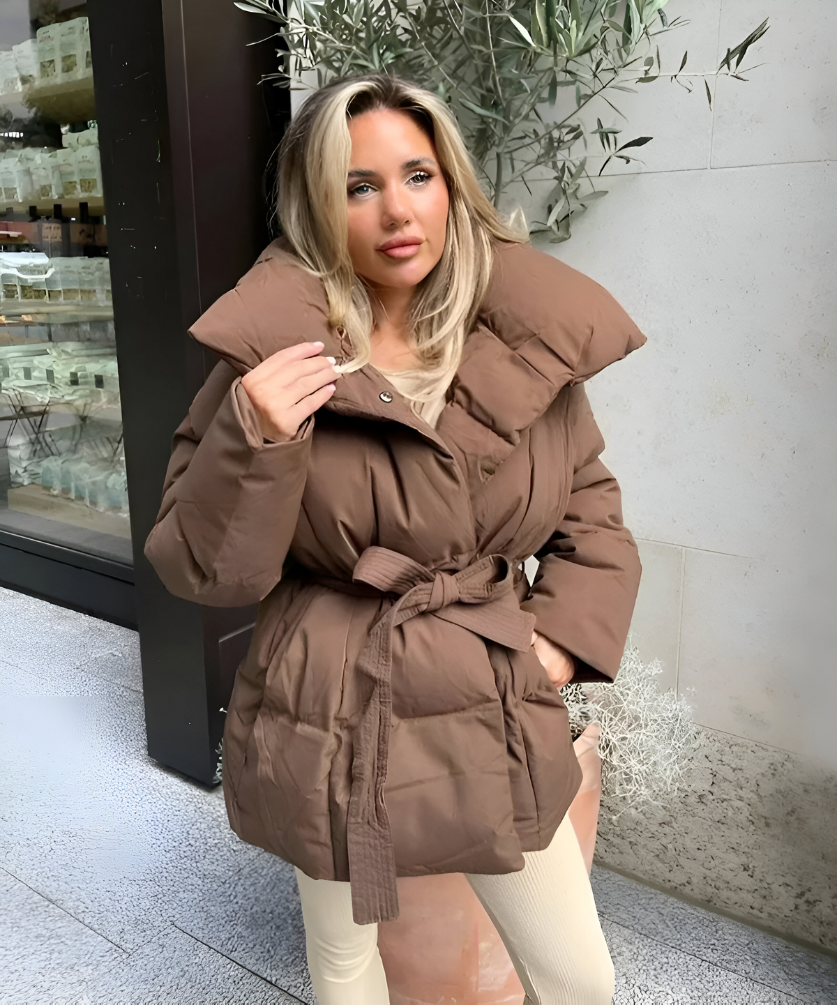 Brown version of the belted puffer jacket featuring a wide stand collar, padded construction, and front waist tie.