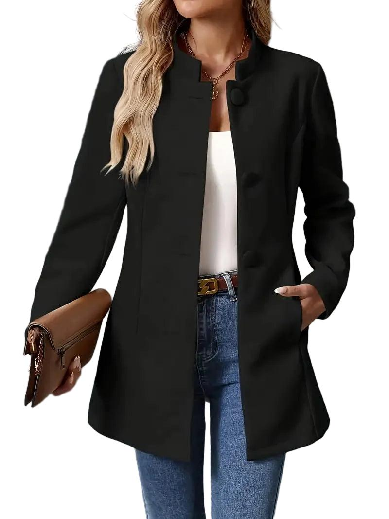 Black button-front longline coat worn open over a white top, with the below-hip length and side pockets visible.