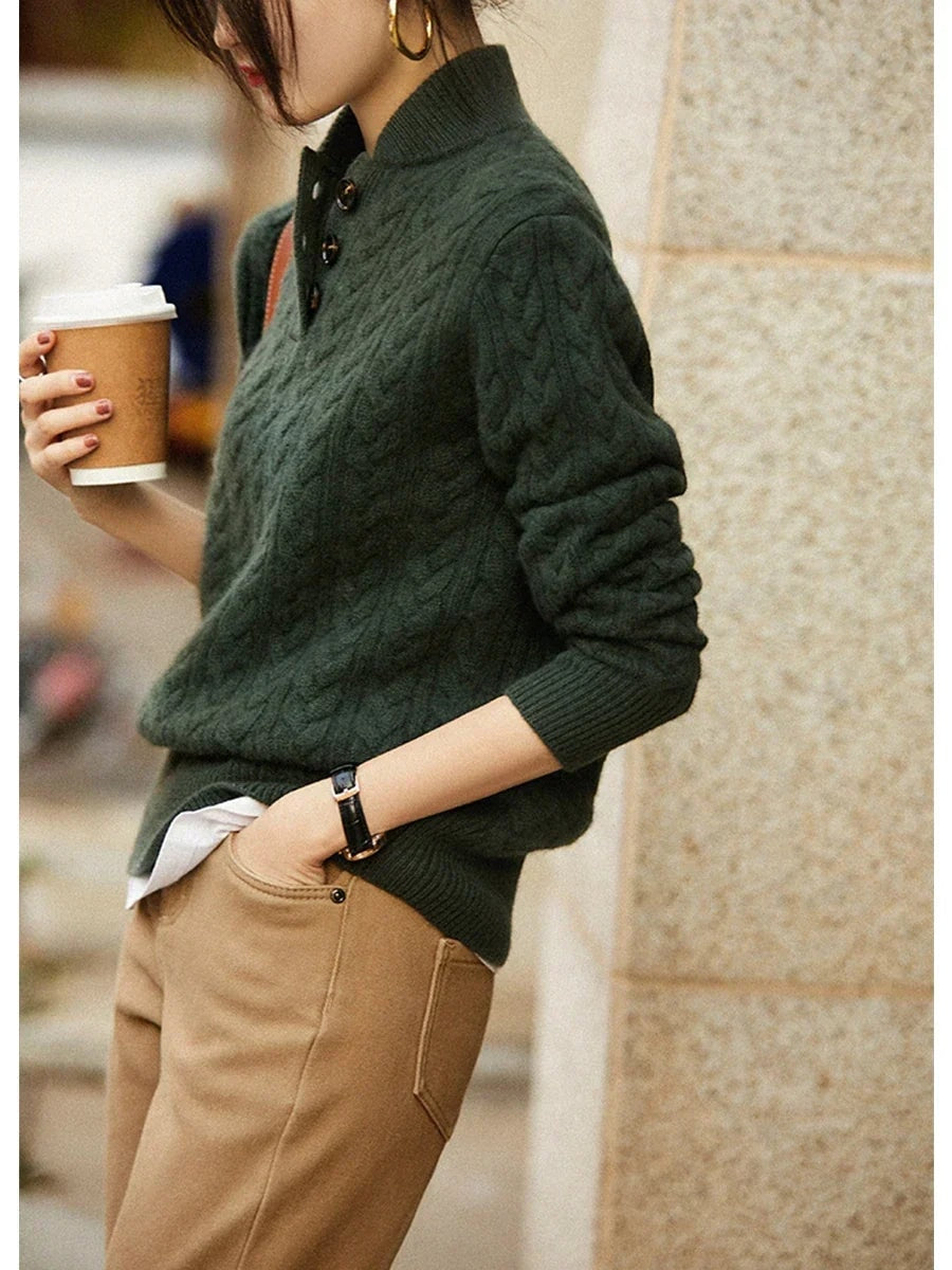 Side profile of the dark green sweater showing the raised cable pattern and fitted sleeve silhouette.