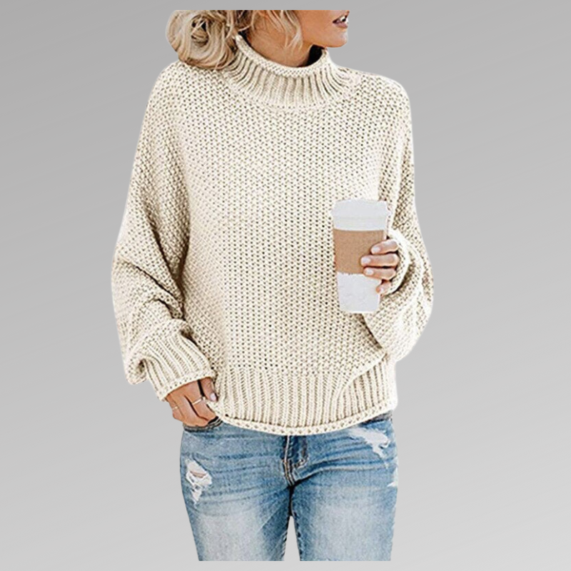 Cream chunky knit turtleneck sweater with full-length sleeves, ribbed cuffs and versatile hip-length coverage.