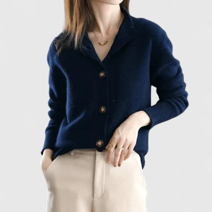 Navy collared cardigan styled with light trousers, highlighting the button-front design, ribbed cuffs, and neat regular-length shape.