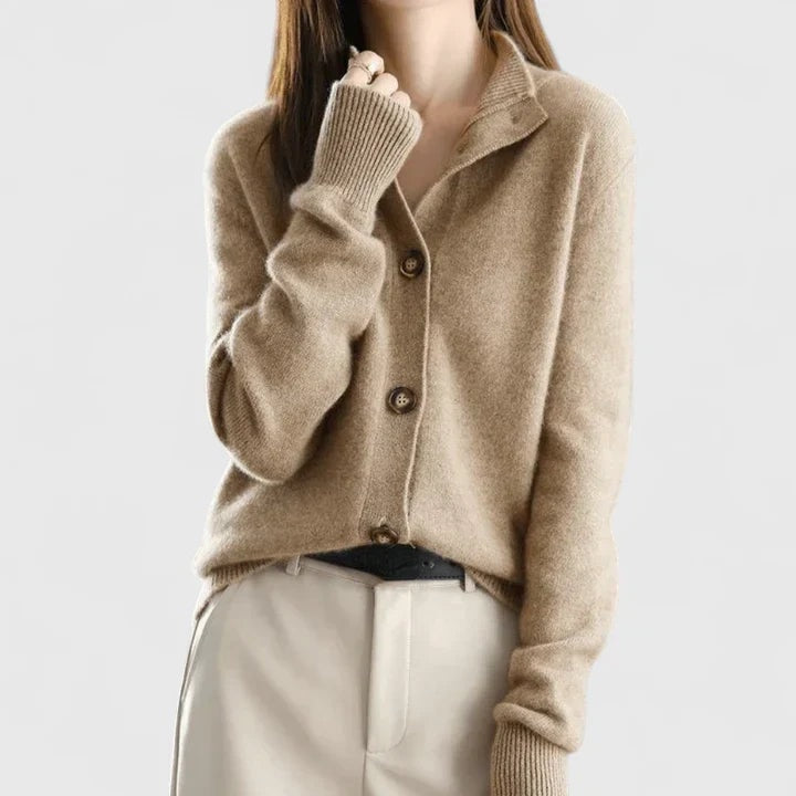 Taupe collared button-front cardigan worn with light trousers, showing its structured collar and ribbed sleeve cuffs.