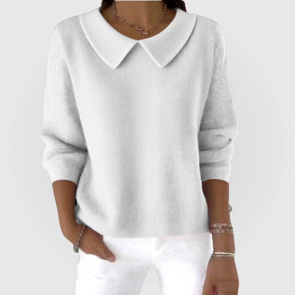White sweater featuring a distinctive pointed collar, relaxed long sleeves, fitted cuffs, and a hip-length cut.