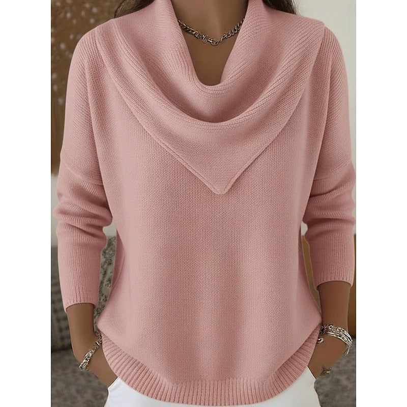 Front view of a pink cowl neck sweater with a draped neckline, long sleeves, ribbed cuffs, and a curved ribbed hem.