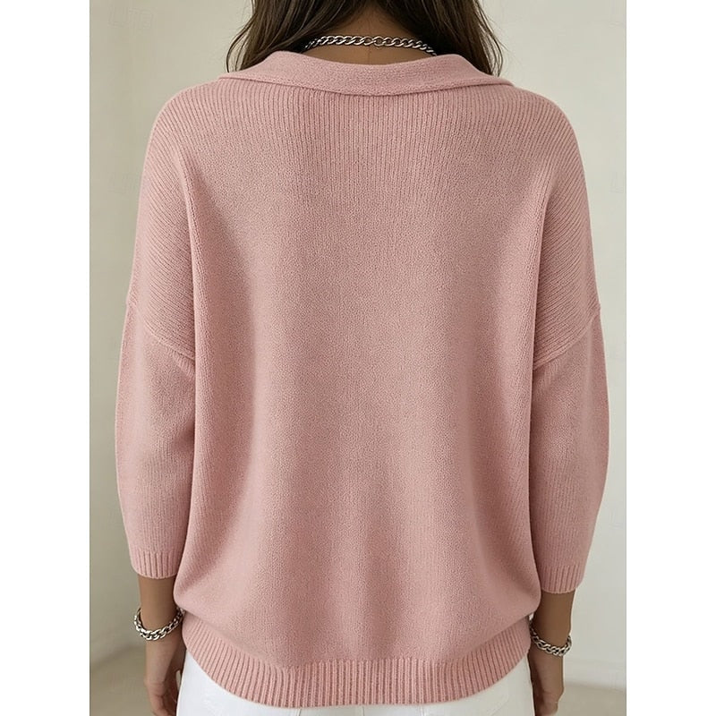 Back view of the pink sweater showing its plain relaxed back, long sleeves, ribbed cuffs, and curved ribbed hem.