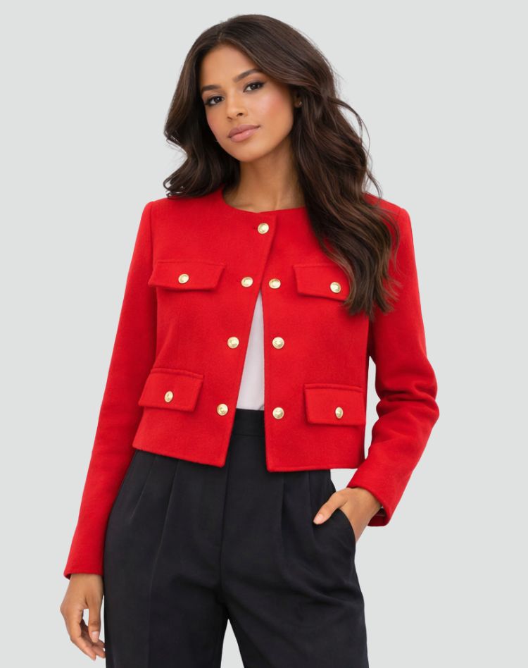 Bright red cropped blazer worn open over a white top, showing the long sleeves and buttoned flap pockets.