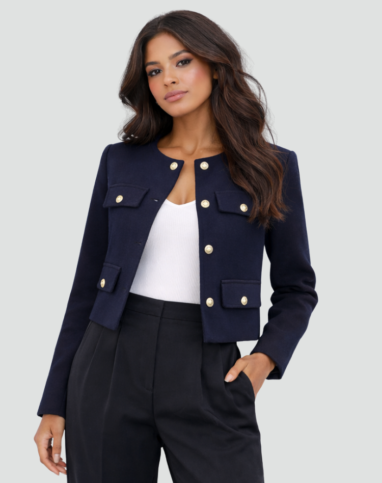 Navy cropped blazer worn open over a white top, showing the split front and gold-tone button details.