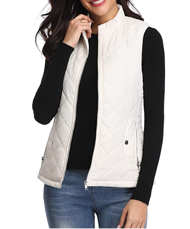 Off-white quilted vest worn open over a black long-sleeve top, highlighting the raised collar and front zipper.