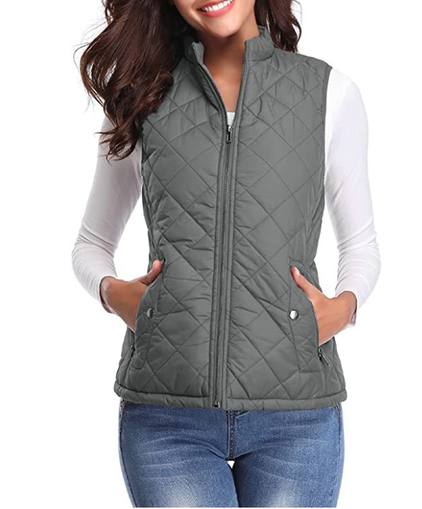 Gray diamond-quilted zip-up vest layered over a white long-sleeve shirt, shown with both hands in the pockets.