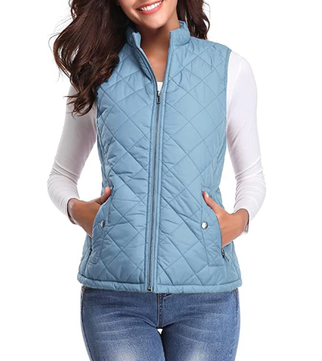 Light blue sleeveless vest featuring diamond quilting and a centered front zipper over a white top.