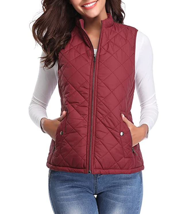 Deep red diamond-quilted vest with a stand collar and two snap-closure pockets, styled with jeans.