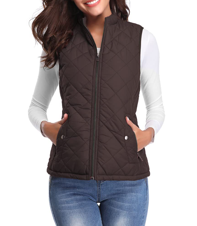 Dark brown diamond-quilted vest with a full front zipper and snap-closure pockets, layered over a white long-sleeve top.