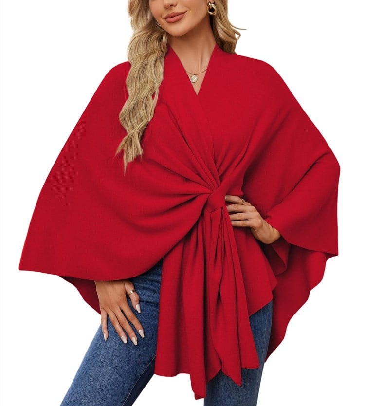 Bright red poncho wrap with a dramatic tied front, wide sleeves, and flowing hem.