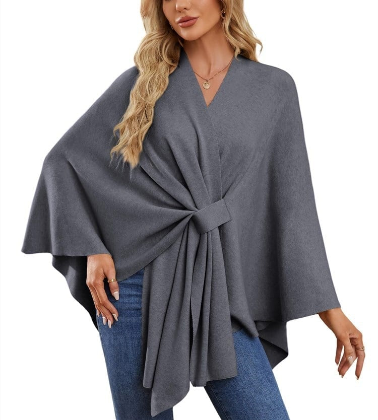 Charcoal gray poncho wrap gathered at the front with a neat tie and long layered drape.
