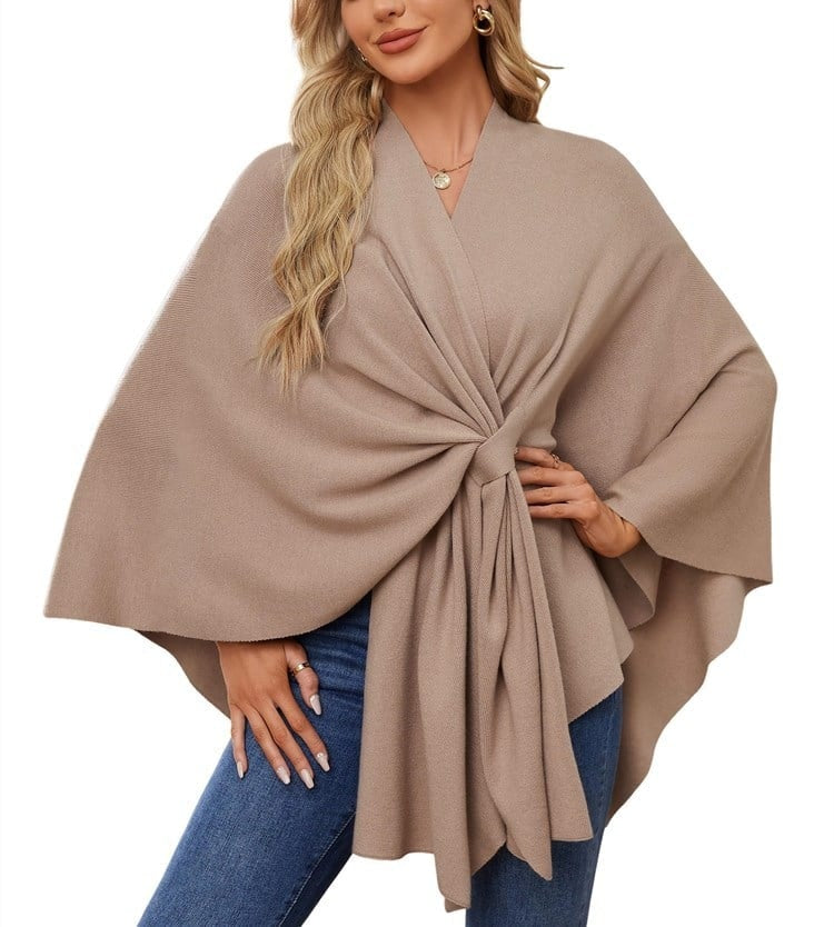 Muted taupe poncho wrap with a flowing tie-front silhouette and broad relaxed sleeves.