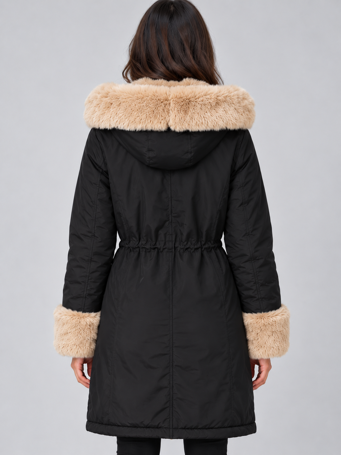 Back view of the black longline parka showing the faux fur hood trim, adjustable waist, and extended coat length.