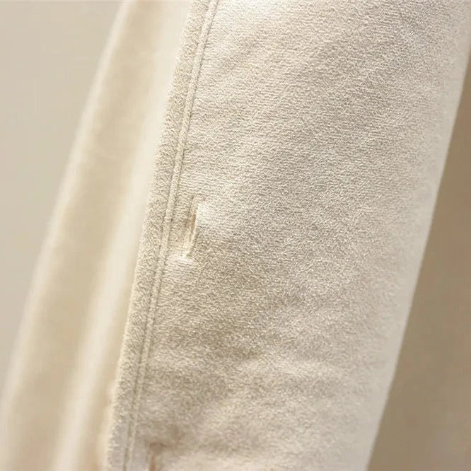 Close-up of the vest’s light inner side, showing the smooth backing, stitched edge and small buttonhole detail.