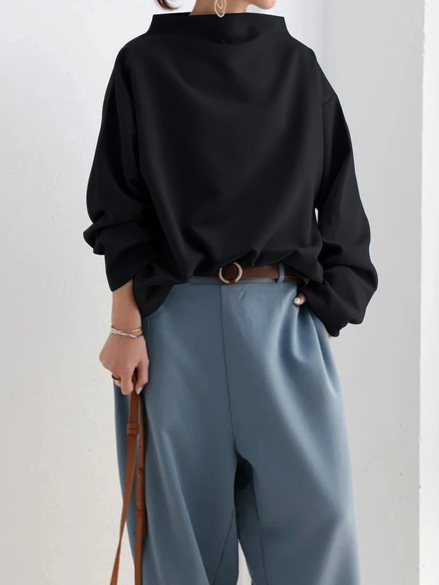 Back view of the solid black sweatshirt, showing its relaxed straight silhouette, high neckline, and gathered cuffs.
