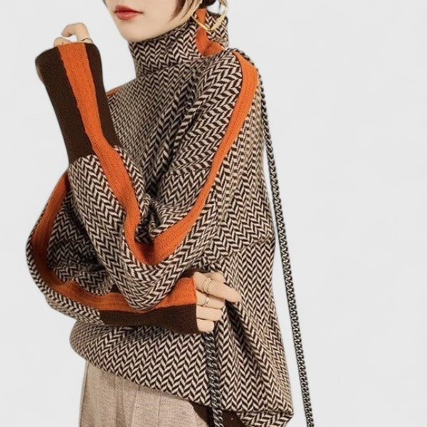 Close side view showing the sweater’s raised neckline, relaxed fit, and layered orange-and-brown sleeve stripes.