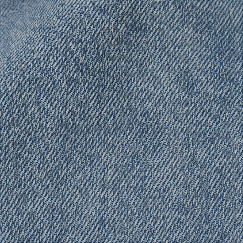 Close-up of the blue woven denim-like surface and diagonal textured weave.