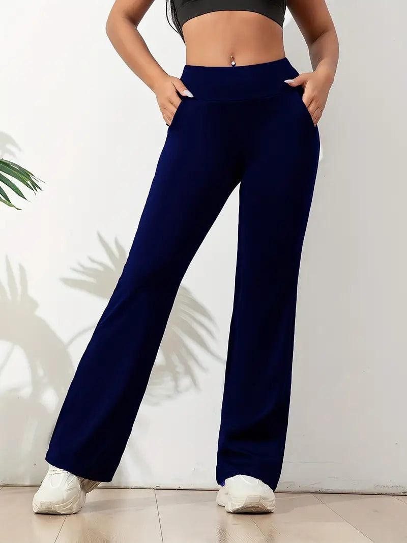 Navy blue full-length flared activewear pants with a wide waistband, shown with white trainers.