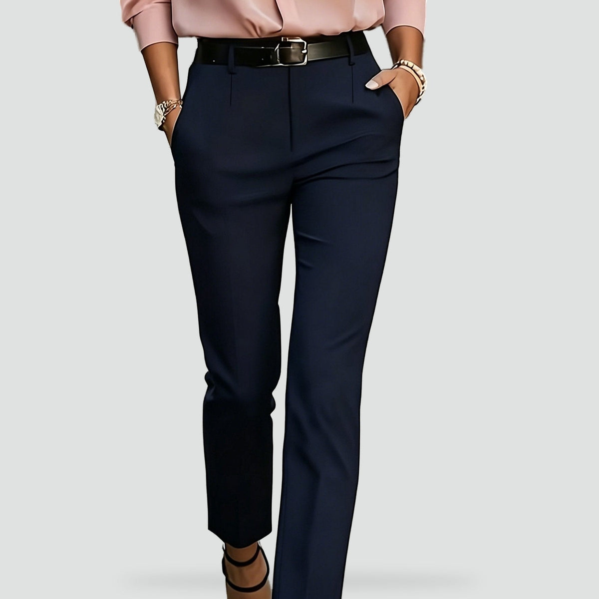 Close front view of navy high-waisted trousers showing belt loops, front closure, and side pockets.