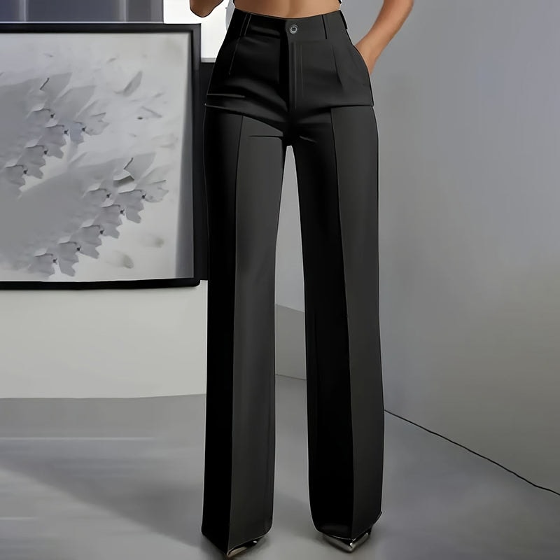 Black high-waisted wide-leg pants shown from the front with long straight panels and pointed shoes underneath.