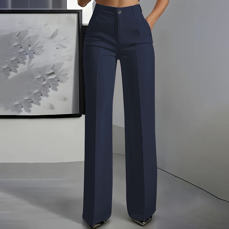 Front view of navy high-waisted wide-leg pants with a buttoned waistband and defined front pleats.