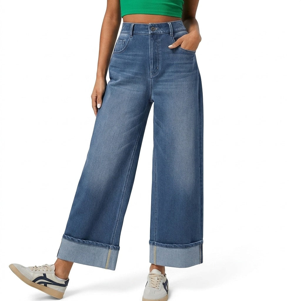 Front view of high-waisted blue wide-leg jeans with a button and zip fly, side pockets, cropped legs, and wide rolled cuffs.