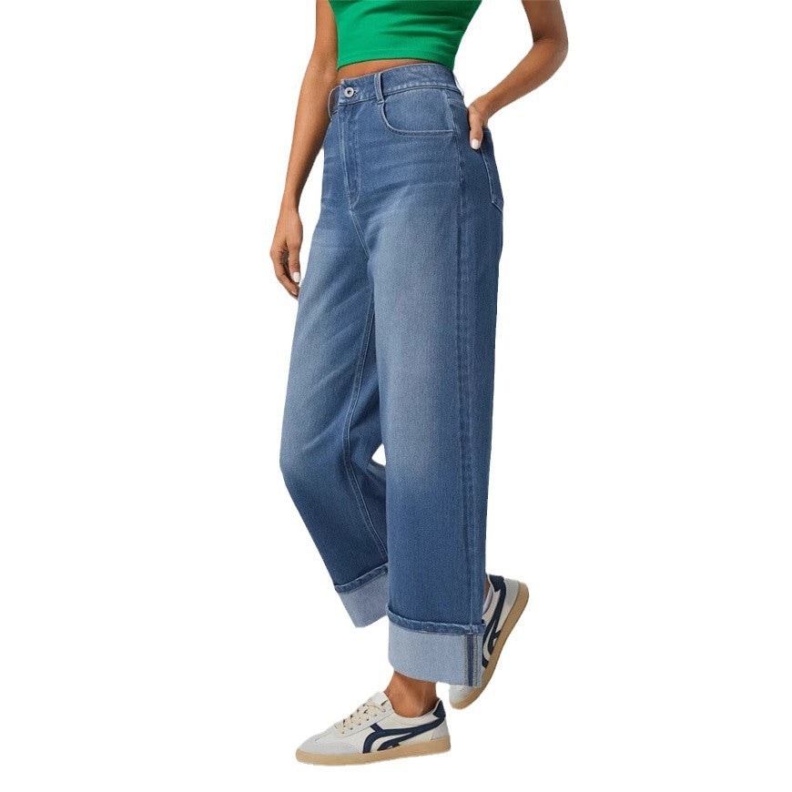 Three-quarter side view of the cuffed wide-leg jeans, emphasizing the curved pocket opening, straight outer seam, and turned-up ankle hem.
