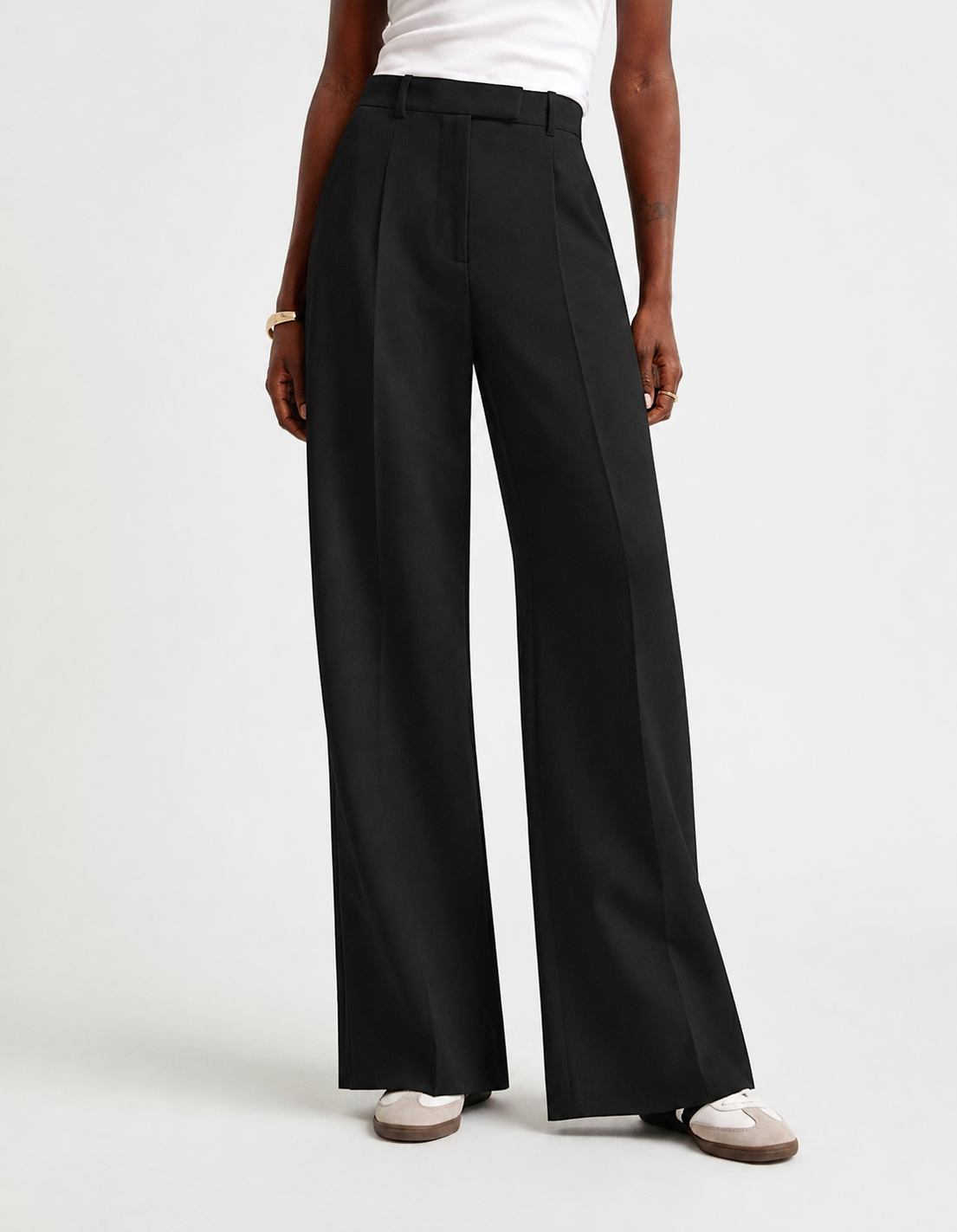 Full-length view of black high-waisted trousers with a clean tailored front and wide legs.