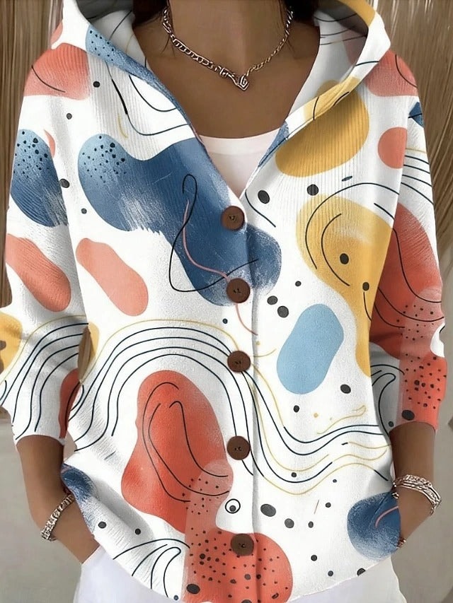 White hooded button-front cardigan featuring colourful abstract shapes, dots, and flowing black line accents.