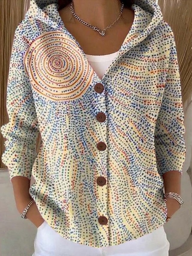 Light-coloured hooded button-front cardigan with a multicolour dotted pattern forming circular and radiating abstract designs.