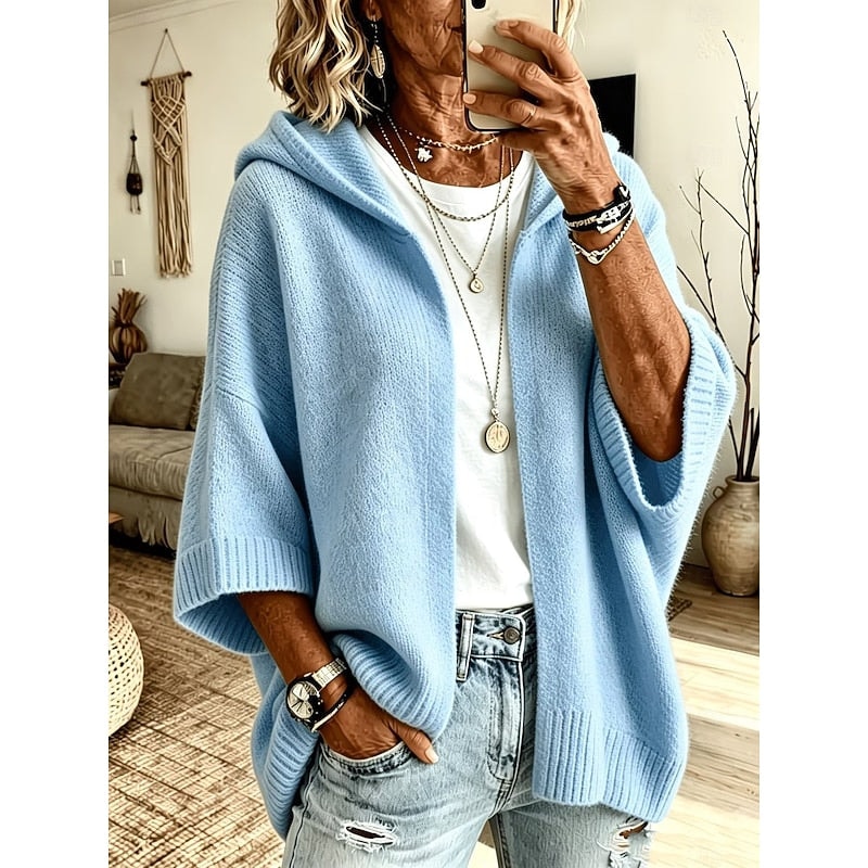Light blue hooded open-front cardigan worn over a white top, shown from the front with wide ribbed sleeve cuffs and hem.