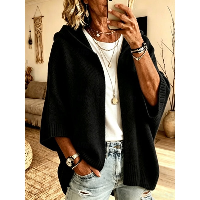 Black hooded open-front cardigan worn over a white top, shown from the front with three-quarter sleeves and defined ribbed trim.