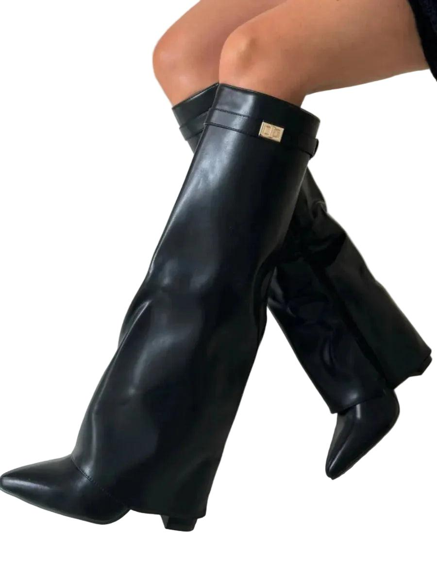 Glossy black knee-high boot shown from the side with a pointed toe, low block heel, and metal accent near the top.