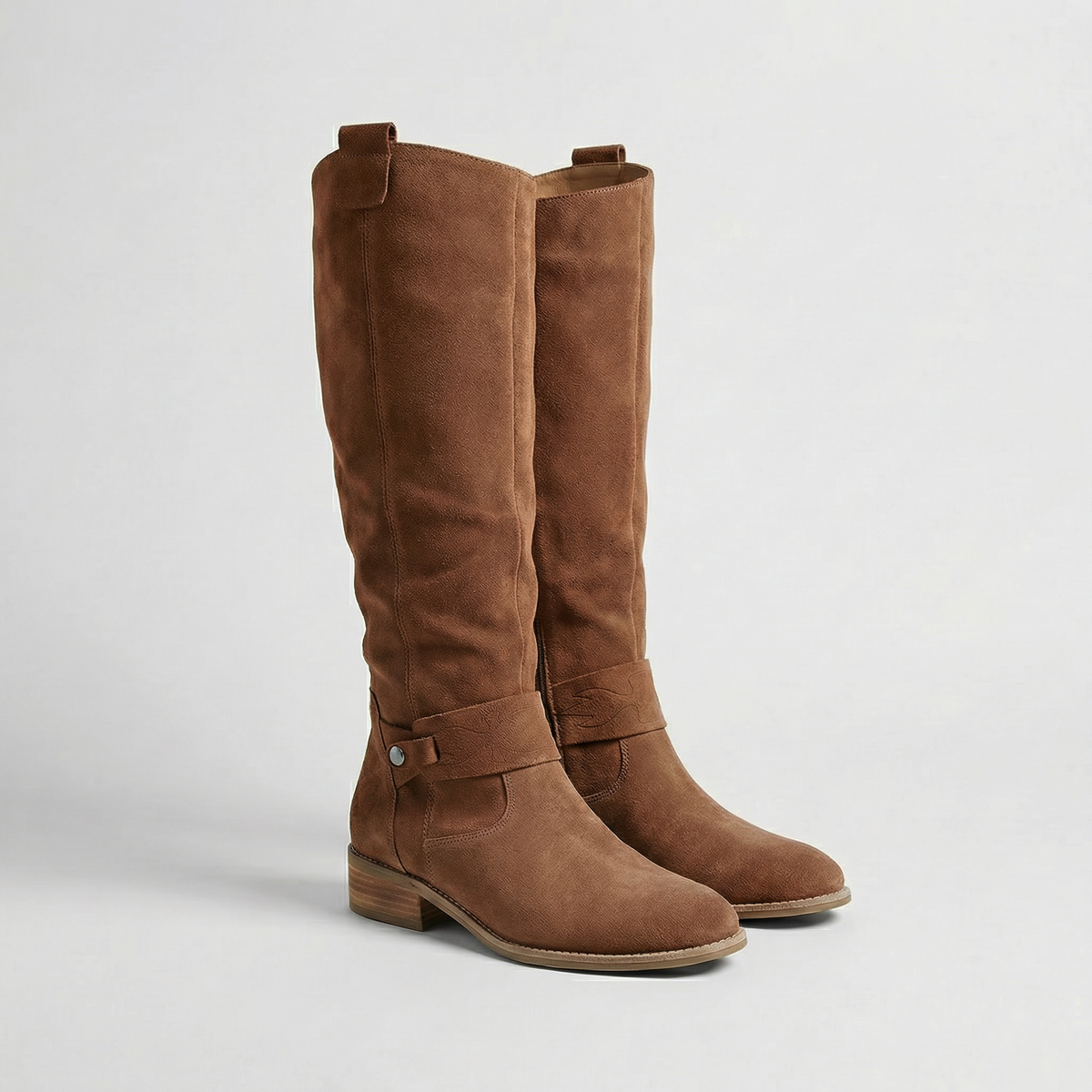 Dark brown knee-high boots with softly gathered shafts, ankle buckles and low block heels displayed as a pair.