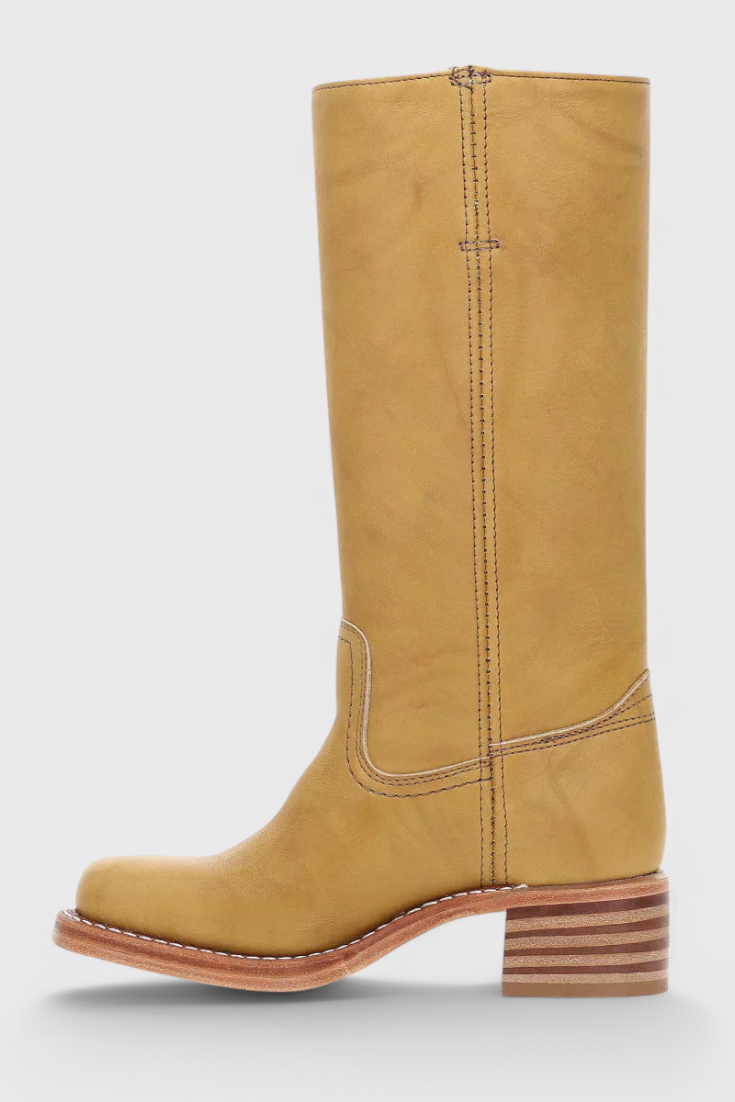 Tan knee-high boot in side profile with a rounded toe, tall shaft, and visibly layered low block heel.