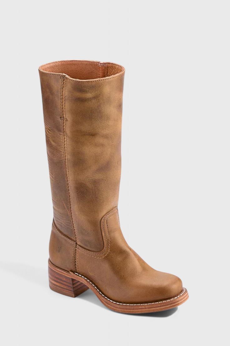 Warm brown knee-high boot angled from above, revealing the open shaft, rounded toe, and stitched ankle panel.