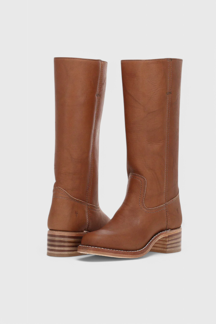 Pair of brown knee-high boots viewed from the back, showing their tall shafts, rear seams, and layered low heels.