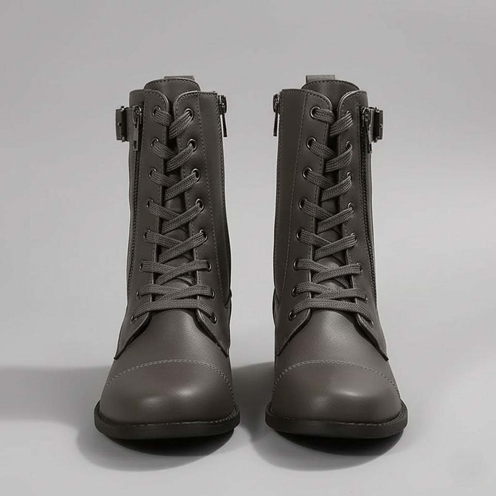 Front view of gray lace-up ankle boots with rounded toes, side zips, buckled ankle straps, and dark soles.