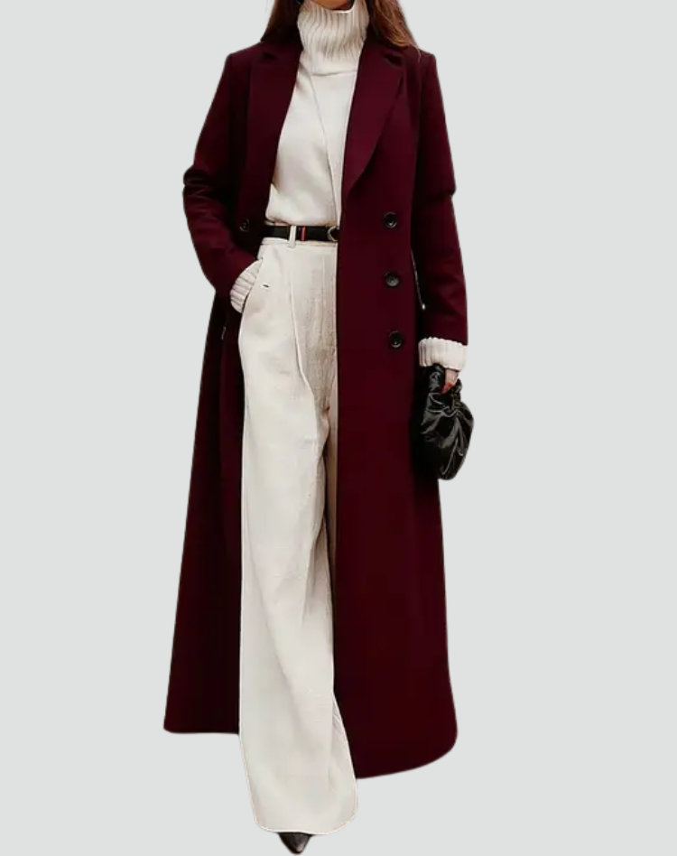 Long burgundy coat with wide lapels and dark buttons, paired with a cream turtleneck and trousers.