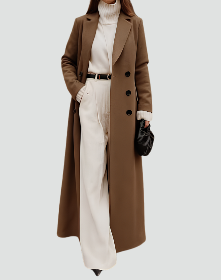 Long brown double-breasted coat with notched lapels, worn over a cream turtleneck and light trousers.