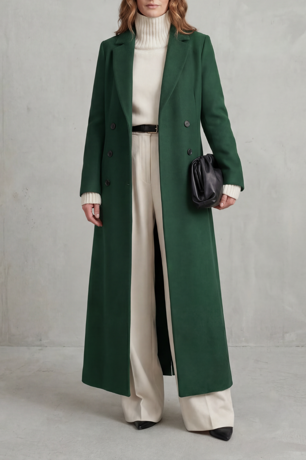 Front view of a dark green long double-breasted tailored coat with notched lapels and a straight full-length cut.