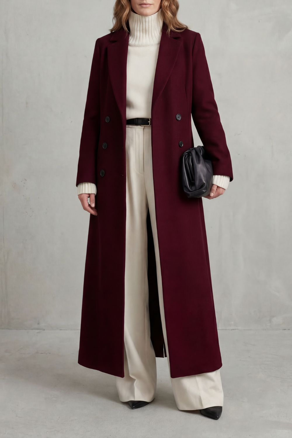 Front view of a deep burgundy full-length double-breasted coat with notched lapels and a straight fit.