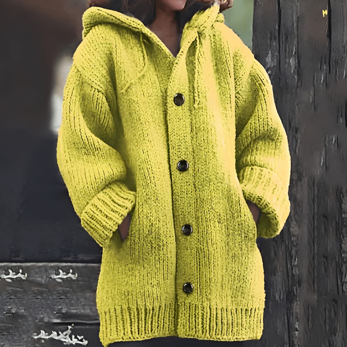 Bright yellow-green hooded chunky knit cardigan shown with its front button closure and two spacious patch pockets.