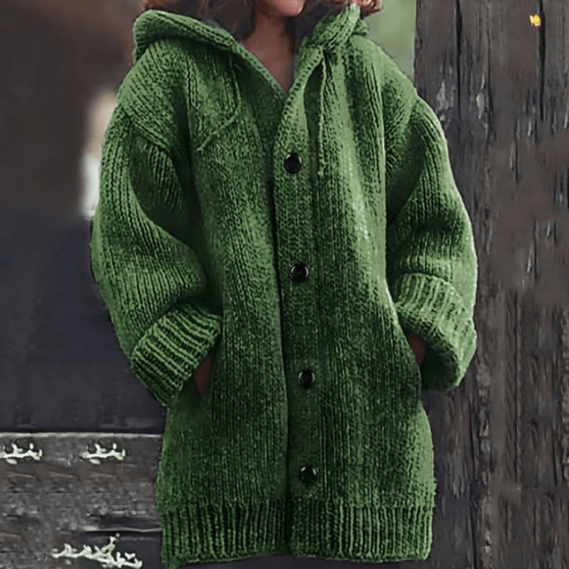 Green chunky knit cardigan with an attached hood, oversized sleeves, button front, and two low front pockets.